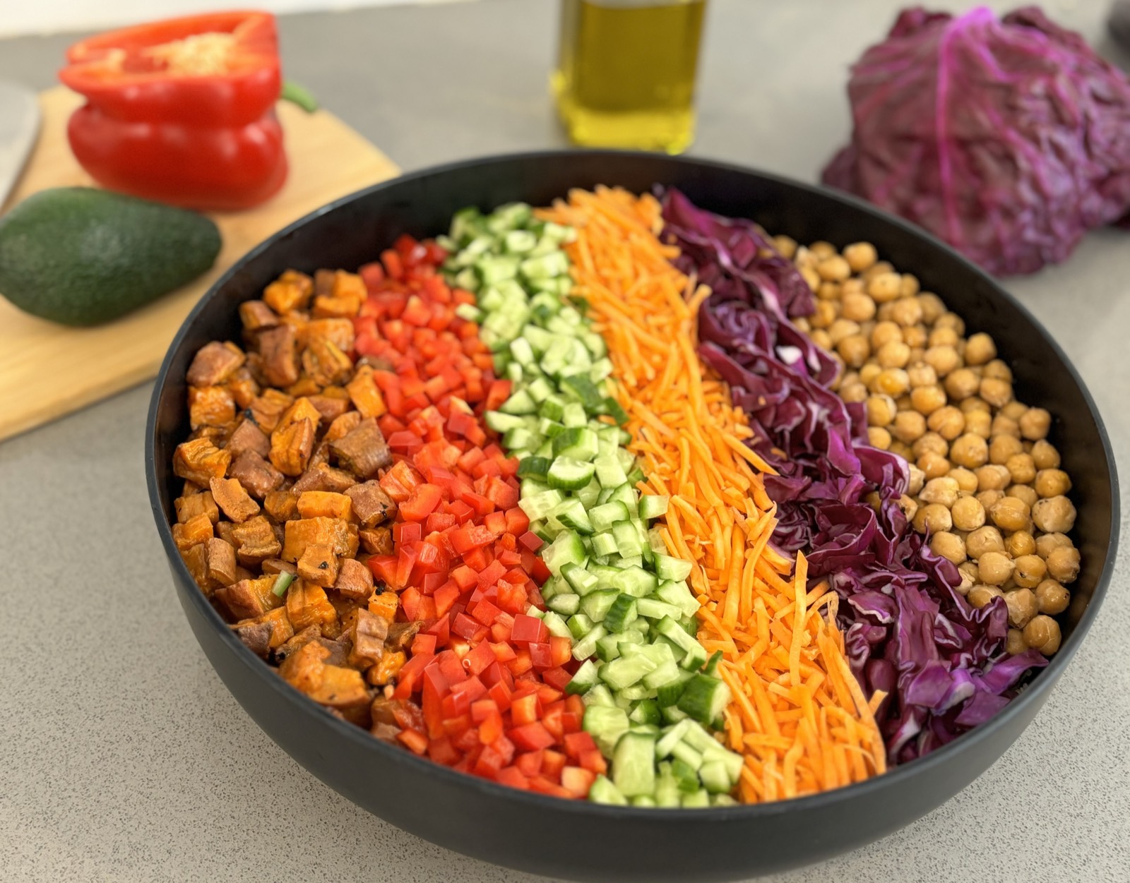 Rainbow quinoa salad with chickpeas, red cabbage, shredded carrots, cucumber, and red pepper